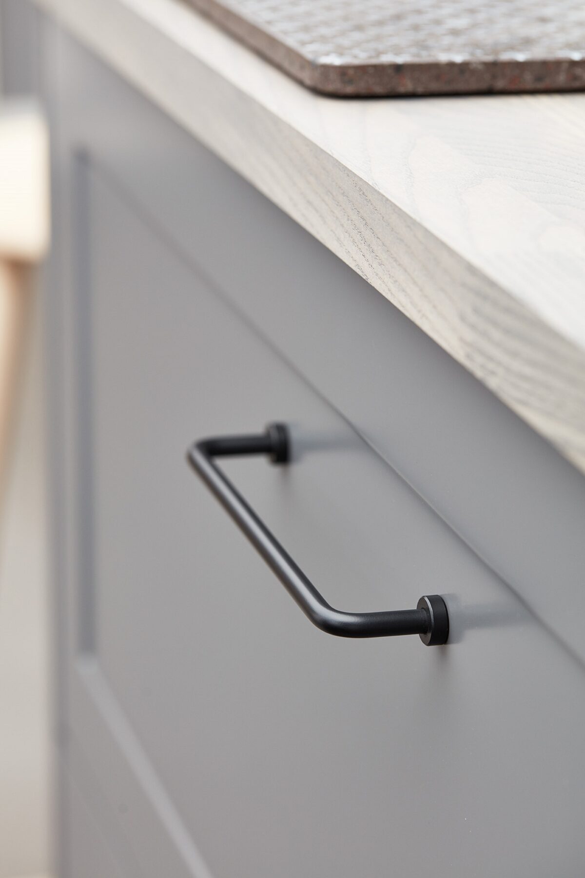 Lounge matt black Zamac cabinet handle with ergonomic concave grip for kitchen cabinets and bespoke furniture.