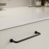 Lounge matt black Zamac cabinet handle with ergonomic concave grip for kitchen cabinets and bespoke furniture.