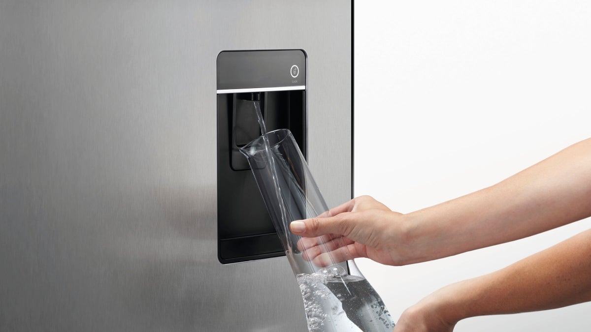 Fisher & Paykel 498L quad door refrigerator freezer with slim external water dispenser, automatic ice maker, and stainless steel finish.