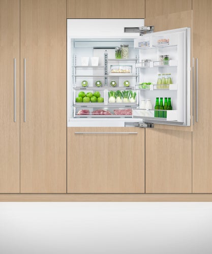fisher-paykel-91cm-integrated-refrigerator-freezer-with-ice-unit-open Fisher & Paykel 91cm integrated refrigerator freezer with automatic ice maker, panel-ready design, and bottom freezer drawer for modern kitchens.