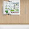 fisher-paykel-left-91cm-integrated-refrigerator-freezer-with-ice-unit-open Fisher & Paykel 91cm integrated refrigerator freezer with automatic ice maker, panel-ready design, and bottom freezer drawer for modern kitchens.