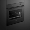 Fisher & Paykel Minimal 16-function built-in oven with black glass finish, touchscreen controls, and self-cleaning technology.