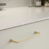 lounge-handle-brushed-brass-lead-free-brass-128cc-lifestyle-1 Lounge brushed brass lead-free brass cabinet handle with ergonomic concave grip for kitchen cabinets and bespoke furniture.