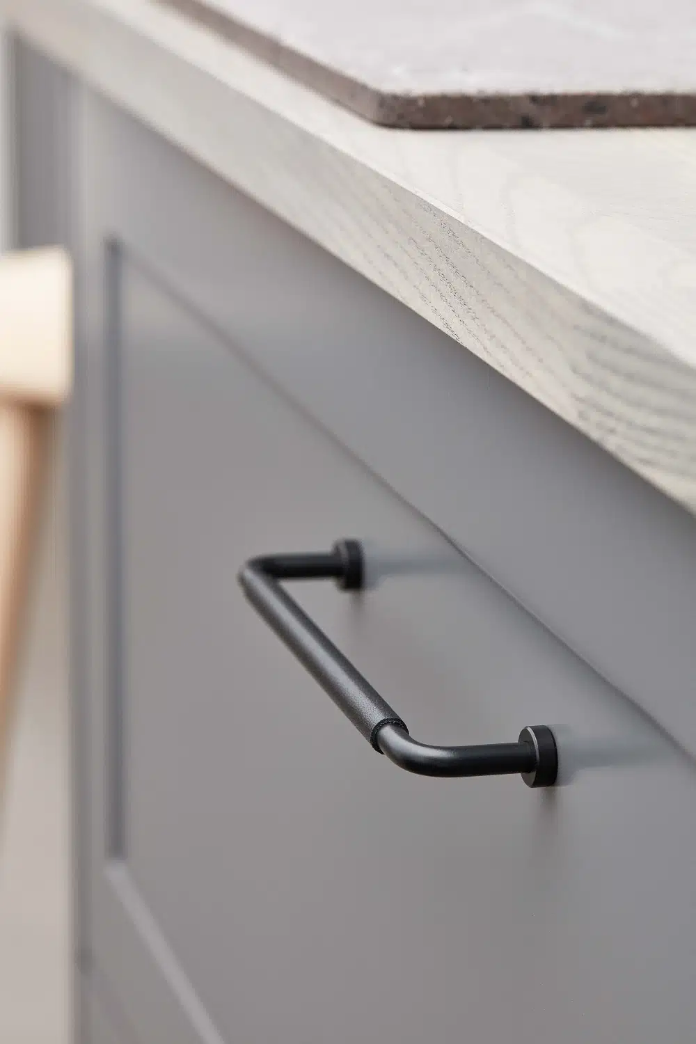Lounge matt black Zamac cabinet handle with ergonomic concave grip for kitchen cabinets and bespoke furniture.