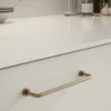 Lounge patinated brass Zamac cabinet handle with ergonomic concave grip for kitchen cabinets and bespoke furniture.