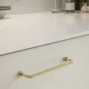 Lounge polished brass Zamac cabinet handle with ergonomic concave grip for kitchen cabinets and bespoke furniture.