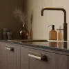 papillon-handle-dark-brown-matt-brass-lifestyle Papillon aluminium cabinet handle in dark brown with matt brass detail for kitchen cabinets, drawers, and bespoke furniture.