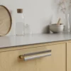papillon-handle-inox-look-clear-lacquered-oak-lifestyle Papillon aluminium cabinet handle with Inox-look finish and clear lacquered oak insert for kitchen cabinets, drawers, and bespoke furniture.