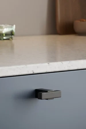 Segment cabinet knob in black stained oak with matt black aluminium detail for kitchen cabinets, drawers, and bespoke furniture.