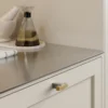 Segment cabinet knob with Inox-look aluminium and clear lacquered oak for kitchen cabinets, drawers, and bespoke furniture.