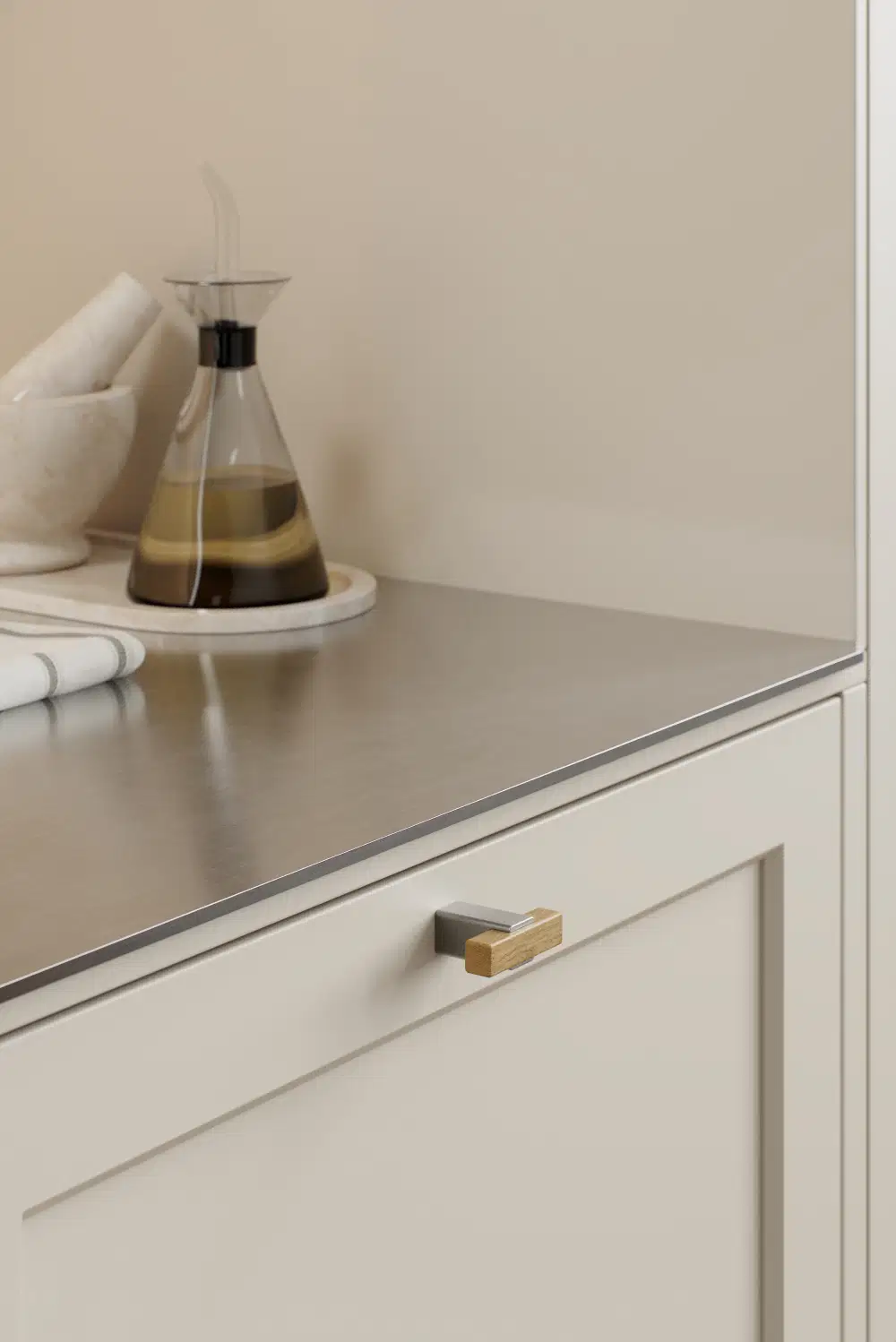 Segment cabinet knob with Inox-look aluminium and clear lacquered oak for kitchen cabinets, drawers, and bespoke furniture.