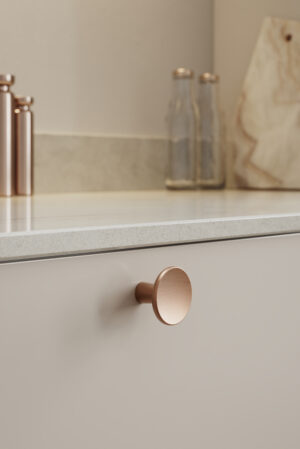 Terra brushed copper cast iron cabinet knob for kitchen cabinets, drawers, wardrobes, and bespoke furniture.