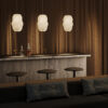 Bloom Oval Pendant Light with tall sculptural white fabric shade and flowing organic form.