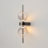 Double Moon black wall light with clear glass shade and contemporary metal detailing.