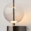Double Moon black wall light with clear glass shade and contemporary metal detailing.