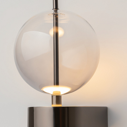 Double Moon black wall light with clear glass shade and contemporary metal detailing.