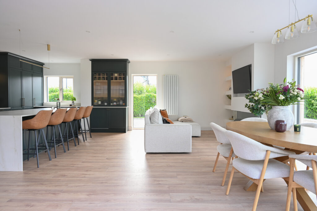 Open-plan kitchen extension with bespoke deep forest green Shaker kitchen, dining area and family living space