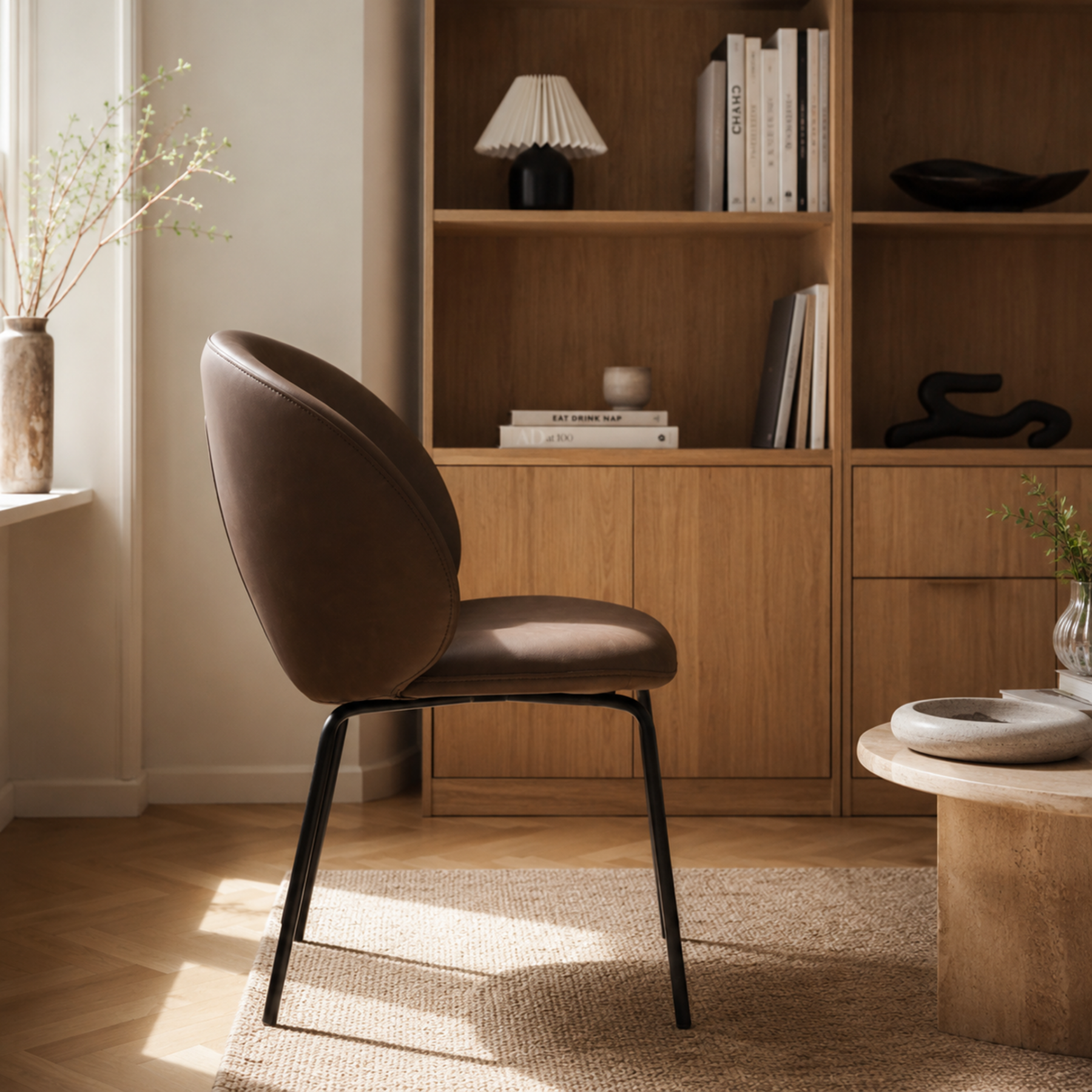 Era Chair in Major Brown faux leather with a rounded upholstered back, padded seat and slim black legs.