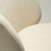 Era Chair in Simply Beige upholstery with rounded backrest, curved seat and slim Antique Brass legs.