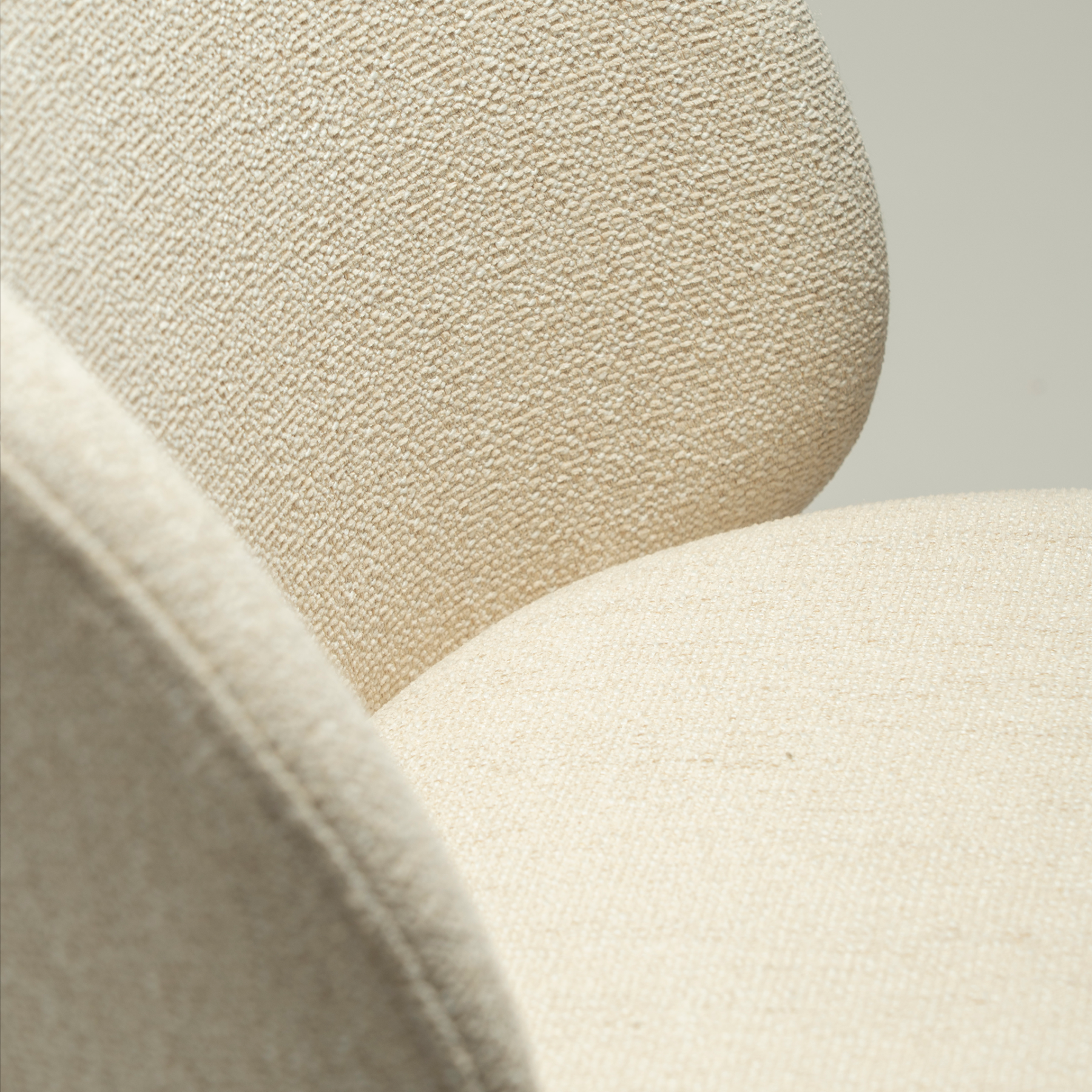 Era Chair in Simply Beige upholstery with rounded backrest, curved seat and slim Antique Brass legs.