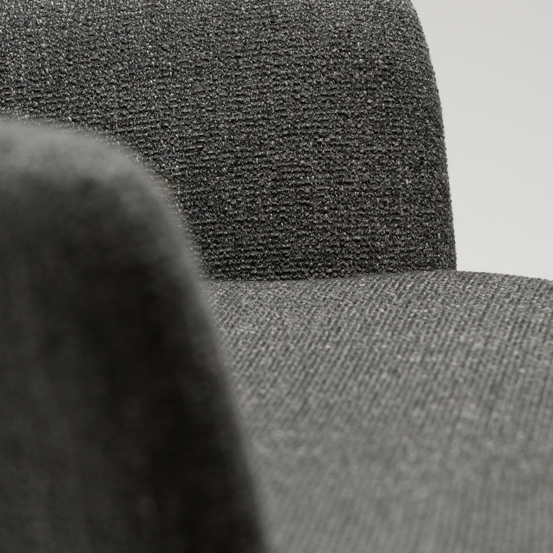 ethos-swivel-armchair-slate-grey-antique-pewter-legs-arm-rest Ethos Swivel Armchair in Slate Grey upholstery with curved armrests and Antique Pewter legs.