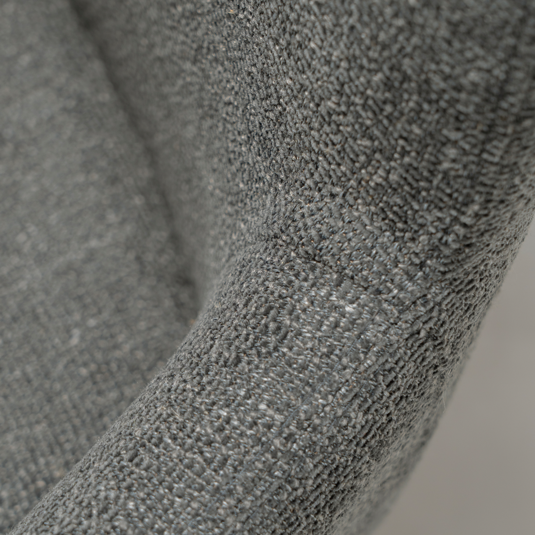 ethos-swivel-armchair-slate-grey-antique-pewter-legs-fabric Ethos Swivel Armchair in Slate Grey upholstery with curved armrests and Antique Pewter legs.