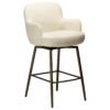 Ethos Swivel Counterstool in Simply Beige upholstery with curved armrests, footrest and Antique Brass legs.