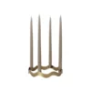 halo-candle-holder-antique-brass Halo four-candle holder in antique brass with sculptural wave-shaped iron frame