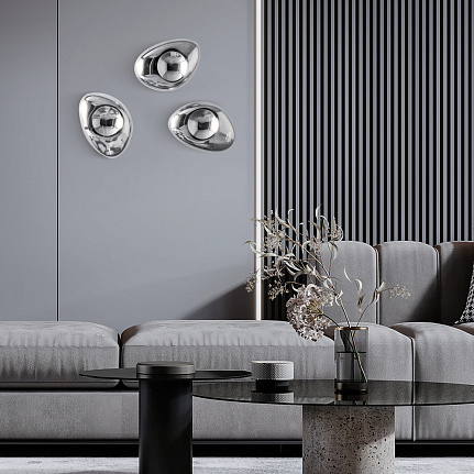 mabell-wall-light-lifestyle Mabell Wall Light with sculptural curved glass shade, reflective finish and exposed central bulb.