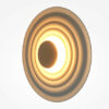 nami-led-wall-light-champagne-angle Nami champagne circular LED wall light with sculptural wave design and warm ambient glow.