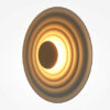 nami-led-wall-light-warm-grey-angled Nami warm grey circular LED wall light with layered wave design and soft 2700K ambient glow.
