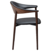 ravish-armchair-raven-black-walnut-veneer-legs-side Ravish Armchair in Raven Black upholstery with curved walnut veneer back, integrated armrests and walnut legs.