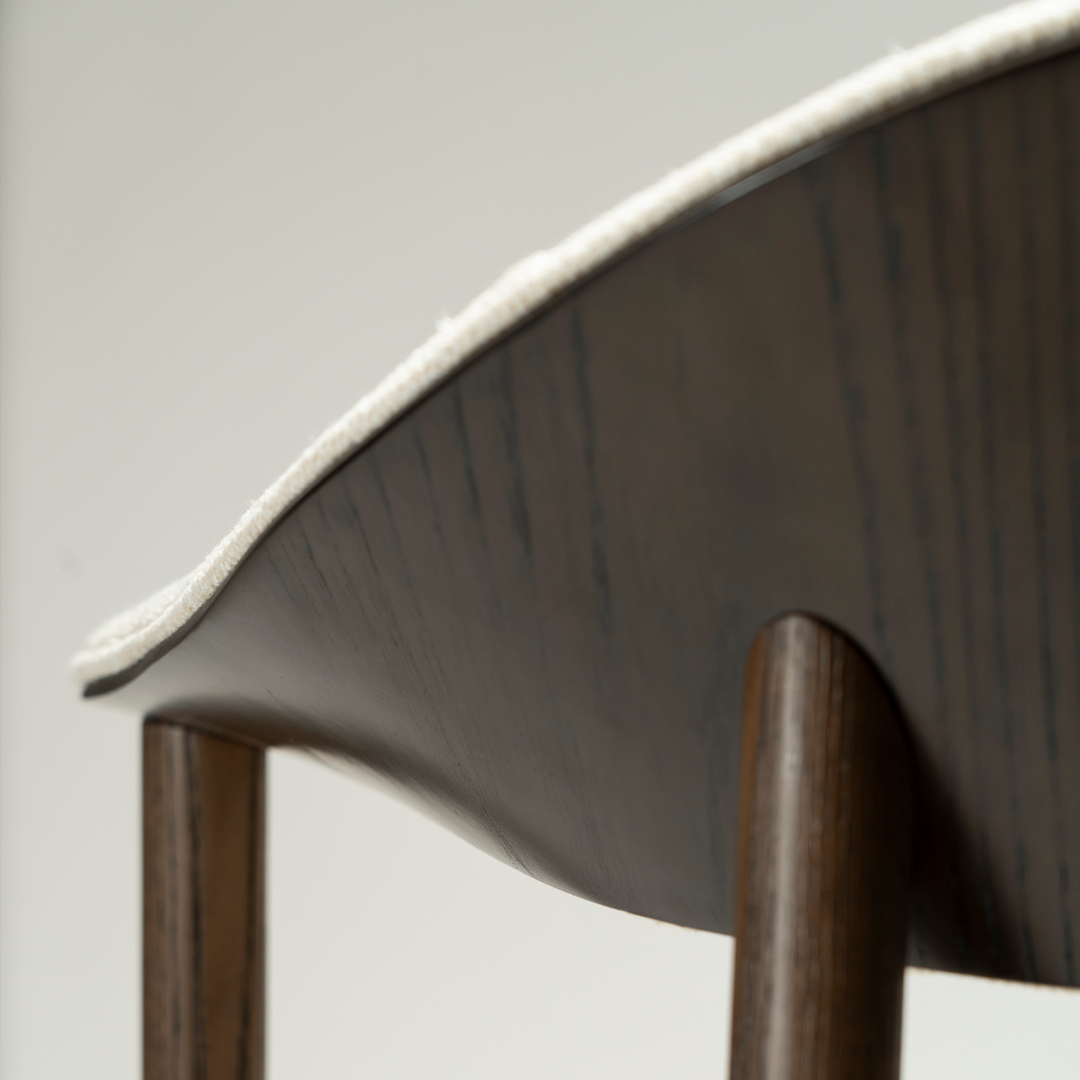 ravish-armchair-simply-beige-boucle-mocca-stained-ash-veneer-close-up Ravish Armchair in Simply Beige bouclé with curved upholstered back, mocca stained ash veneer and matching timber legs.
