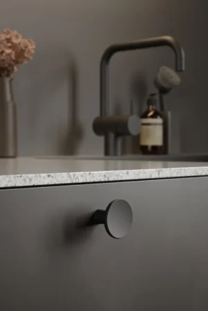 Terra matt black cast iron cabinet knob for kitchen cabinets, drawers, wardrobes, and bespoke furniture.