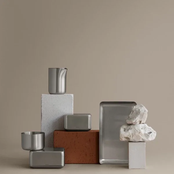 Stainless steel butter dish styled with coordinating stainless steel kitchen accessories