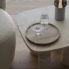 Koyoi Champagne Coupe in clear glass styled with coordinating glassware on a contemporary travertine coffee table
