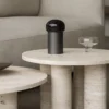 Koyoi Champagne Coupe in clear glass styled on a travertine side table in a contemporary living room