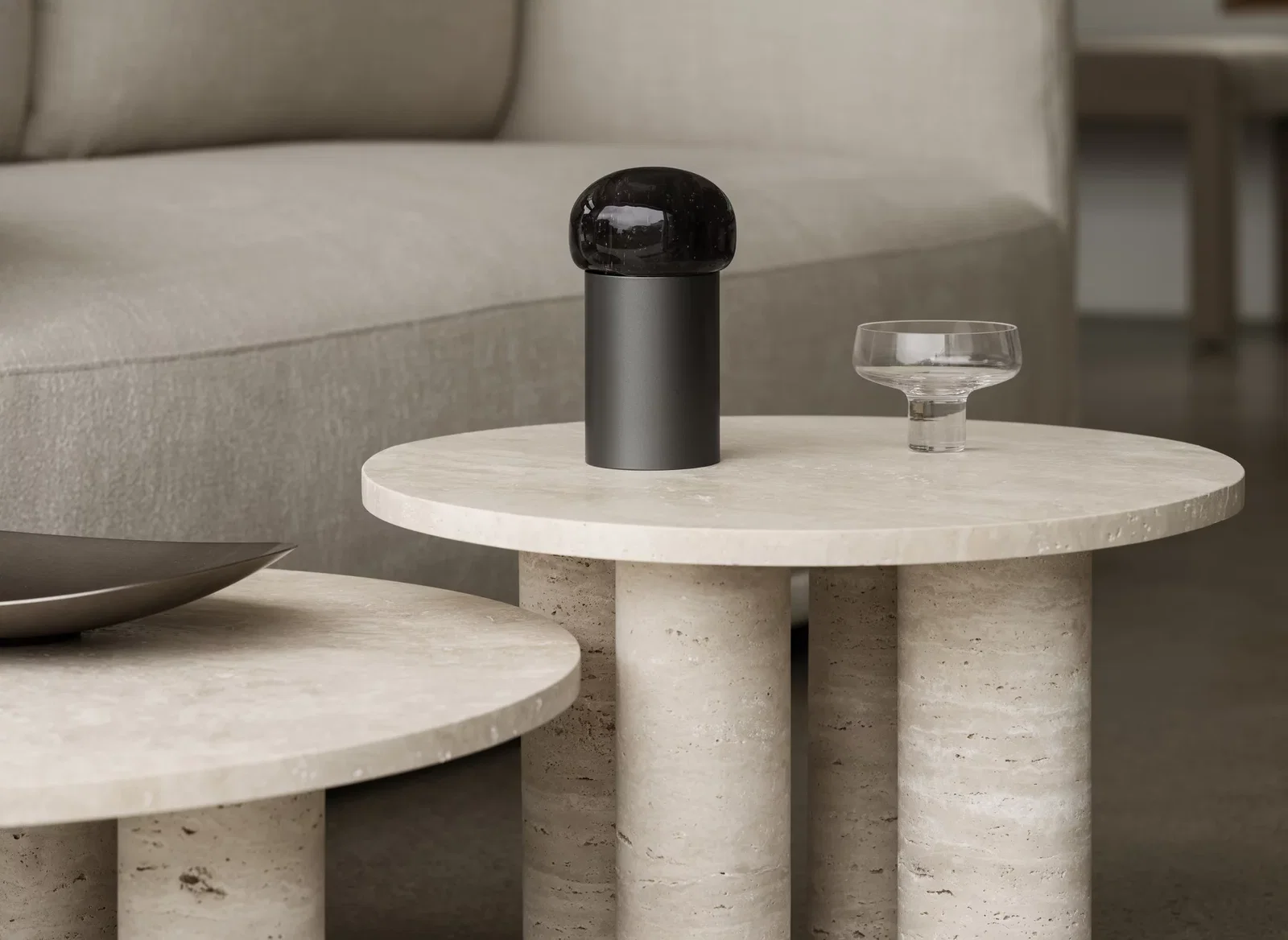 Koyoi Champagne Coupe in clear glass styled on a travertine side table in a contemporary living room