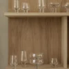 Koyoi clear glass Champagne Coupes displayed with coordinating mouth-blown glassware on oak shelving