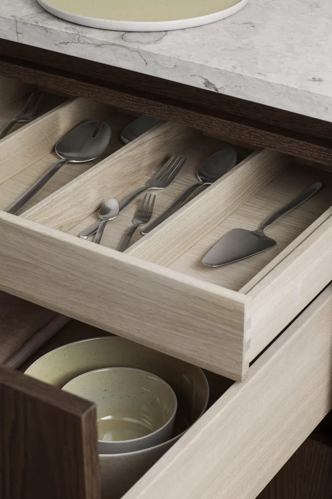 Stainless steel salad servers in oak cutlery drawer