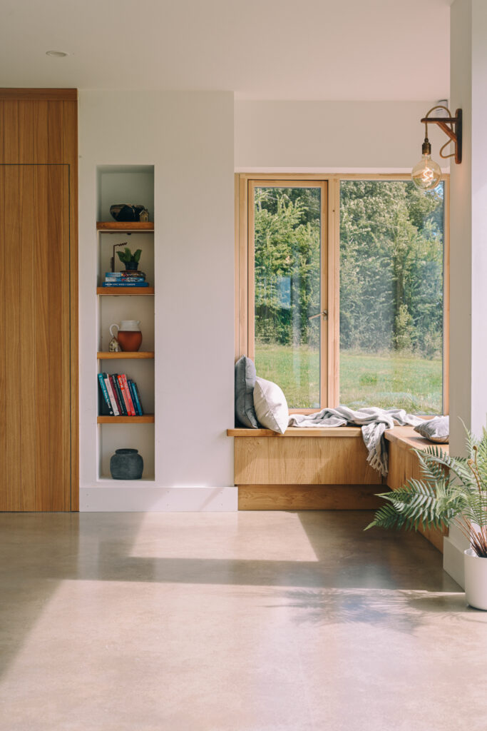 A bespoke window seat at large window.